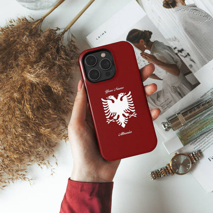 a person holding a red phone case with a white bird on it
