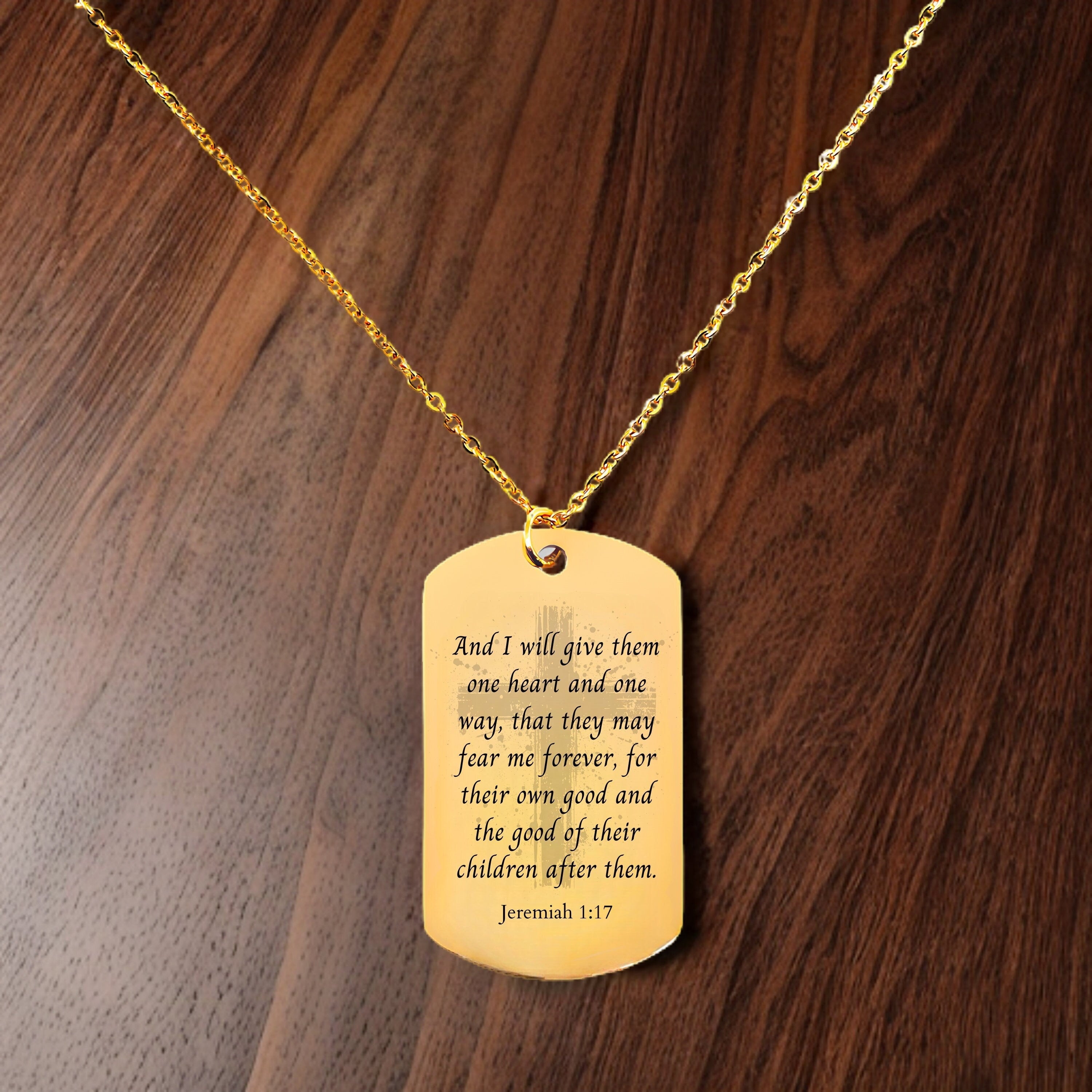a gold dog tag with a bible verse on it